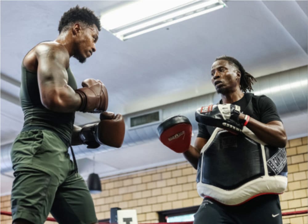 Moe Kayongo (right) trains an up-and-comer at the Northside Boxing Club in north Minneapolis.